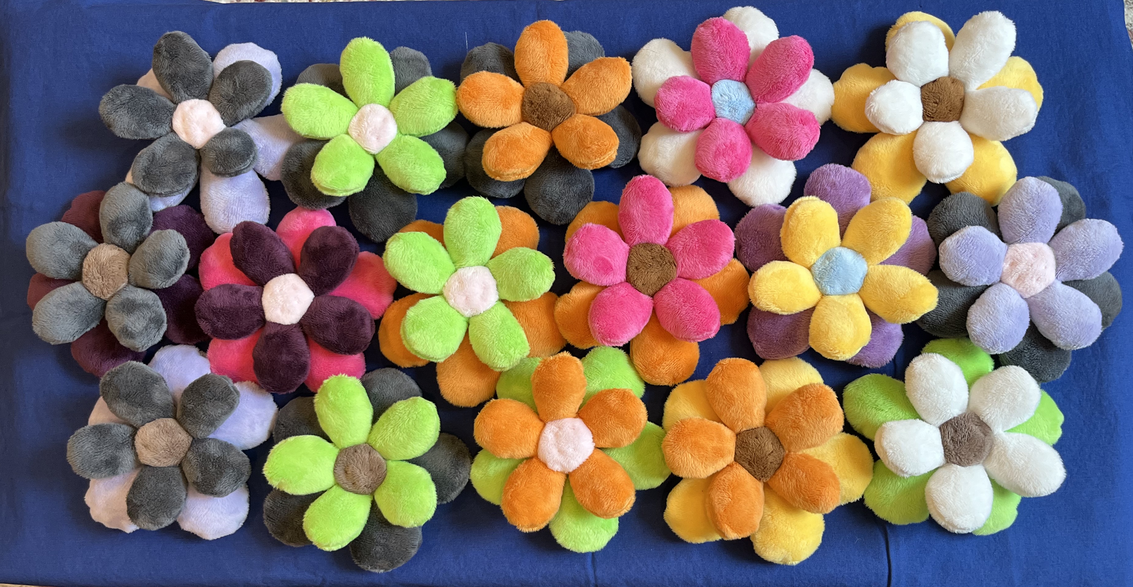 Lots of multicolored plush flowers arranged to look like a meadow.