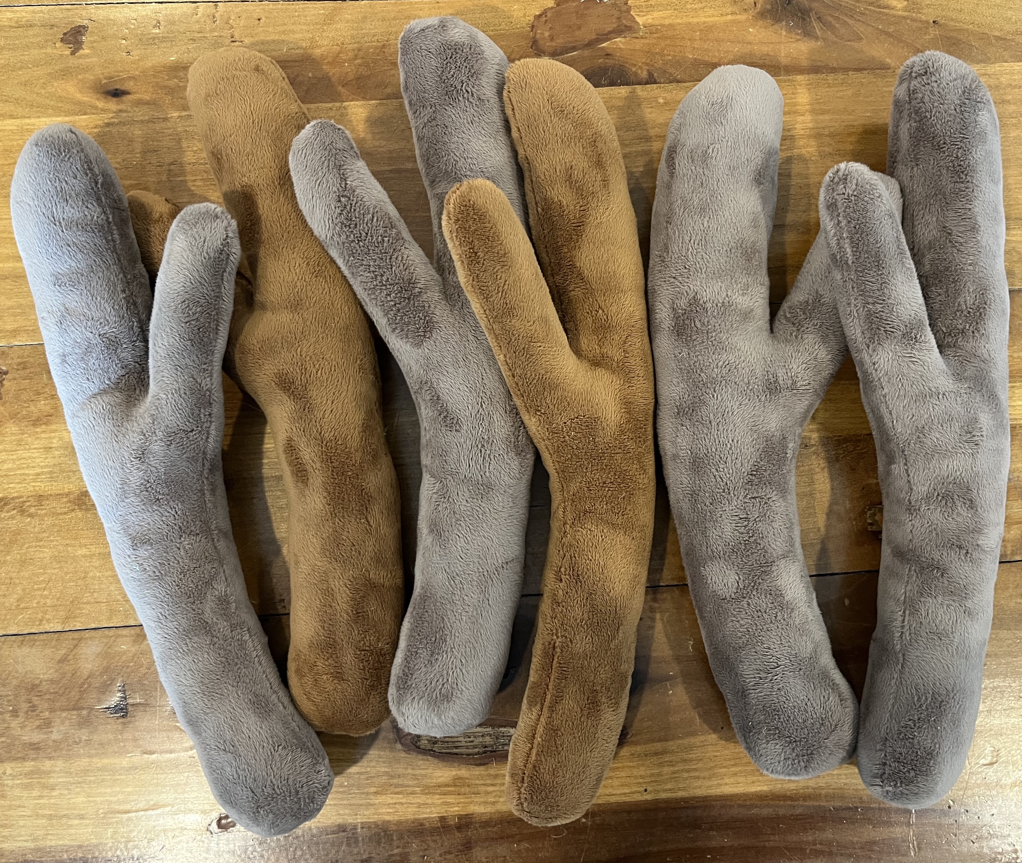 A pile of brown plush sticks laying on a wooden table
